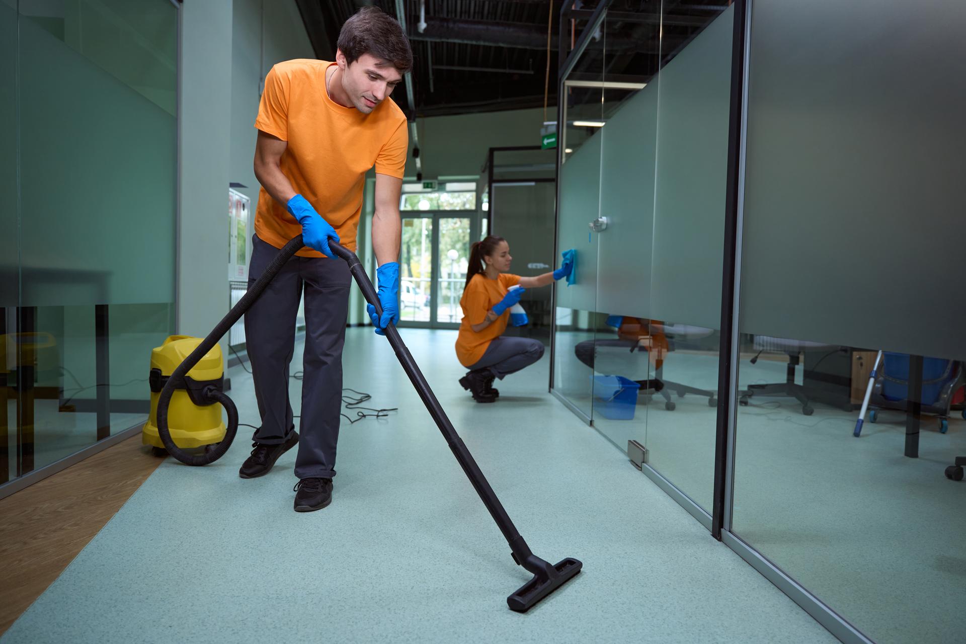 Team of professional cleaners tidying up the room